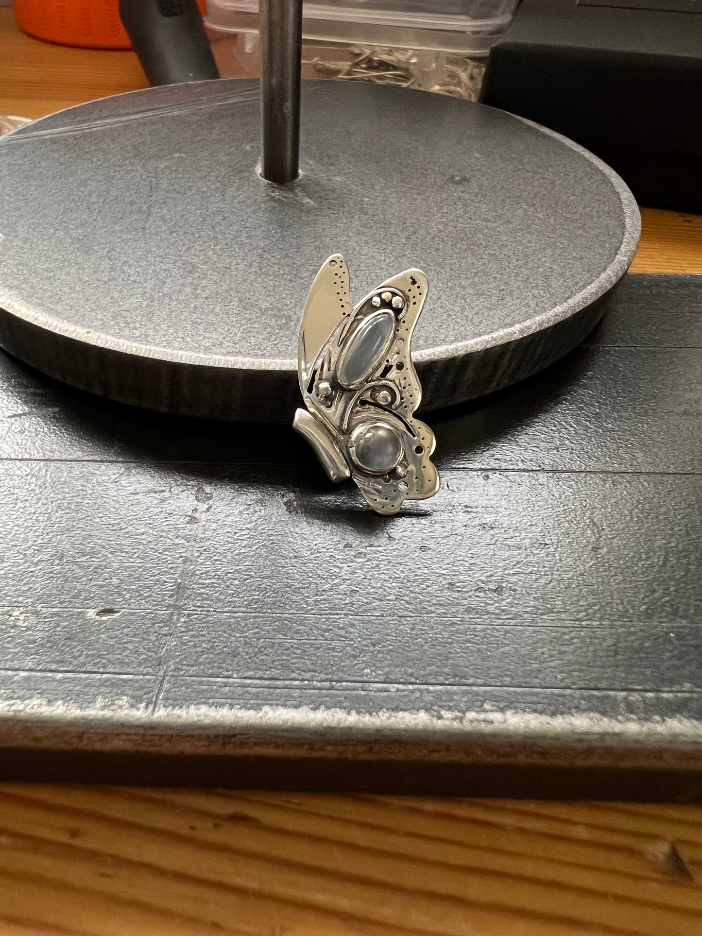 Sterling Silver Butterfly Pendant with Grey Moonstones – detail shot of sterling silver butterfly pendant showing grey moonstone and oxidized metalwork texture, black backgroun