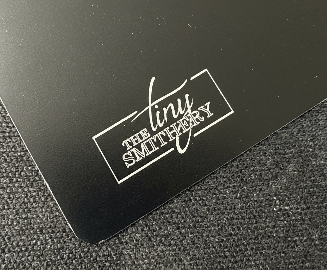 Black surface with 'The Smithery' logo in white