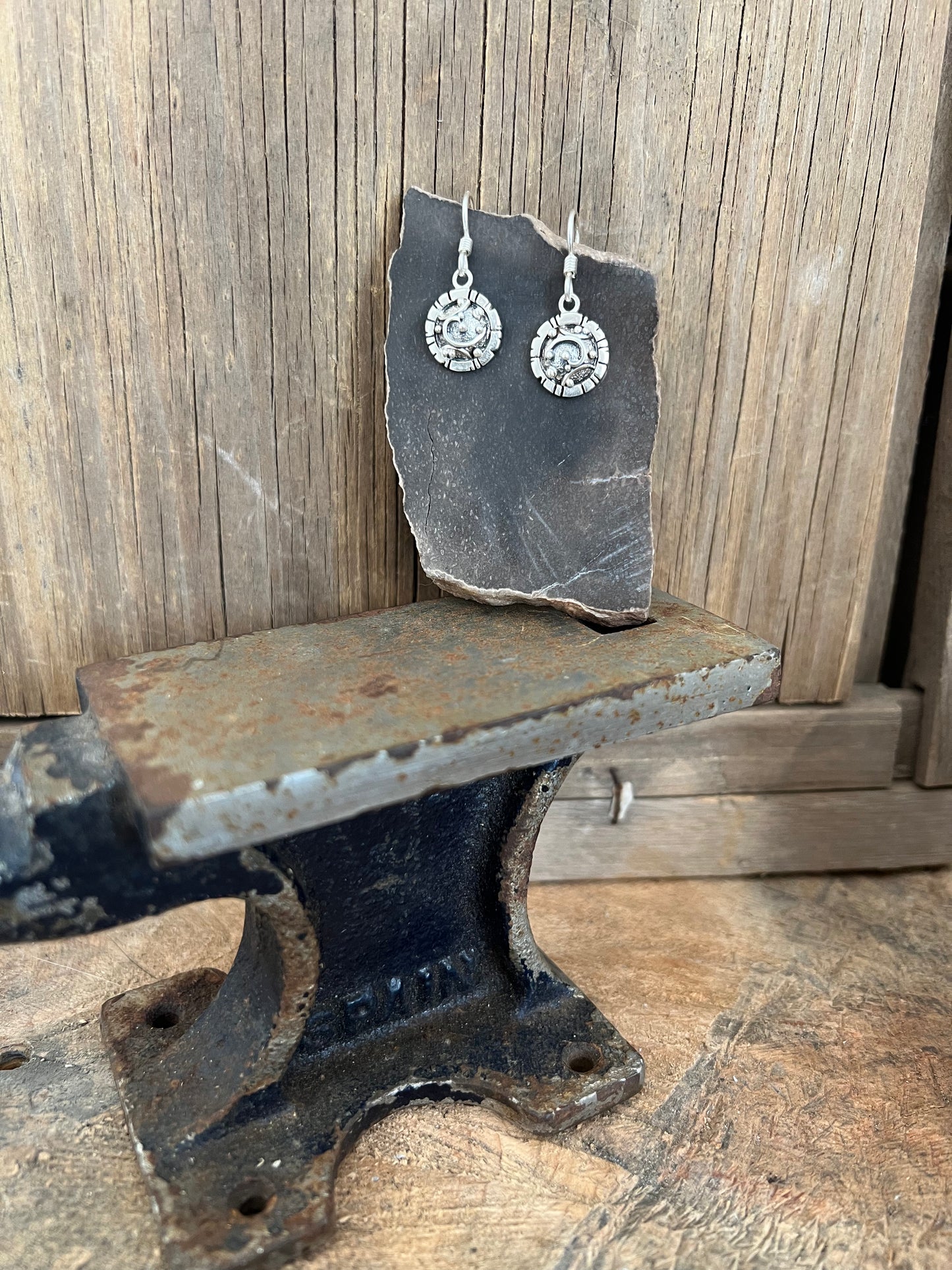 Artisanal Elements Earrings – lifestyle shot of sterling silver artisanal elements disc drop earrings, natural light
