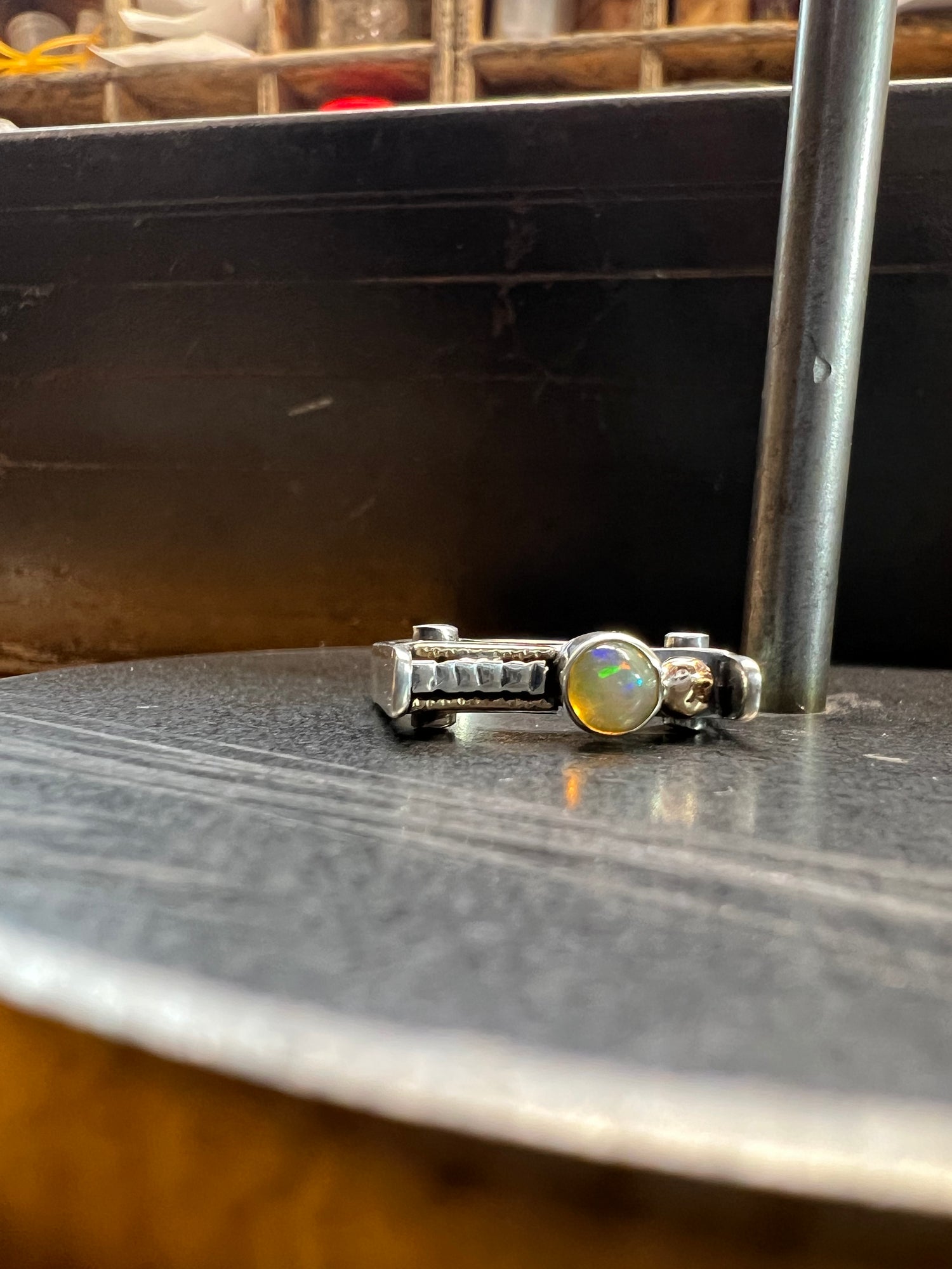 Sterling Silver Bar Ring with Opal and Yellow Gold Accents – handcrafted sterling silver bar-style band ring with bezel-set white opal and yellow gold accent details, black background
