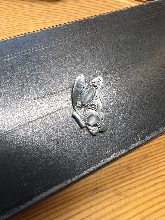 Sterling Silver Butterfly Pendant with Grey Moonstones – close-up of sterling silver butterfly pendant showing bezel-set grey moonstone cabochons on wing details, black background