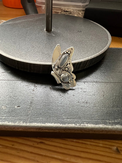 Sterling Silver Butterfly Pendant with Grey Moonstones – detail shot of sterling silver butterfly pendant showing grey moonstone and oxidized metalwork texture, black backgroun