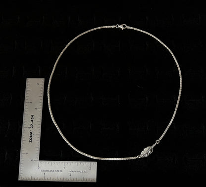 Embedded Feather Necklace – size reference showing sterling silver embedded feather resin pendant approximately 1 inch wide next to ruler, black background