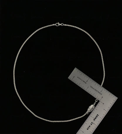 Embedded Feather Necklace – side view of sterling silver bezel-set resin pendant with natural feather detail on box chain, black background