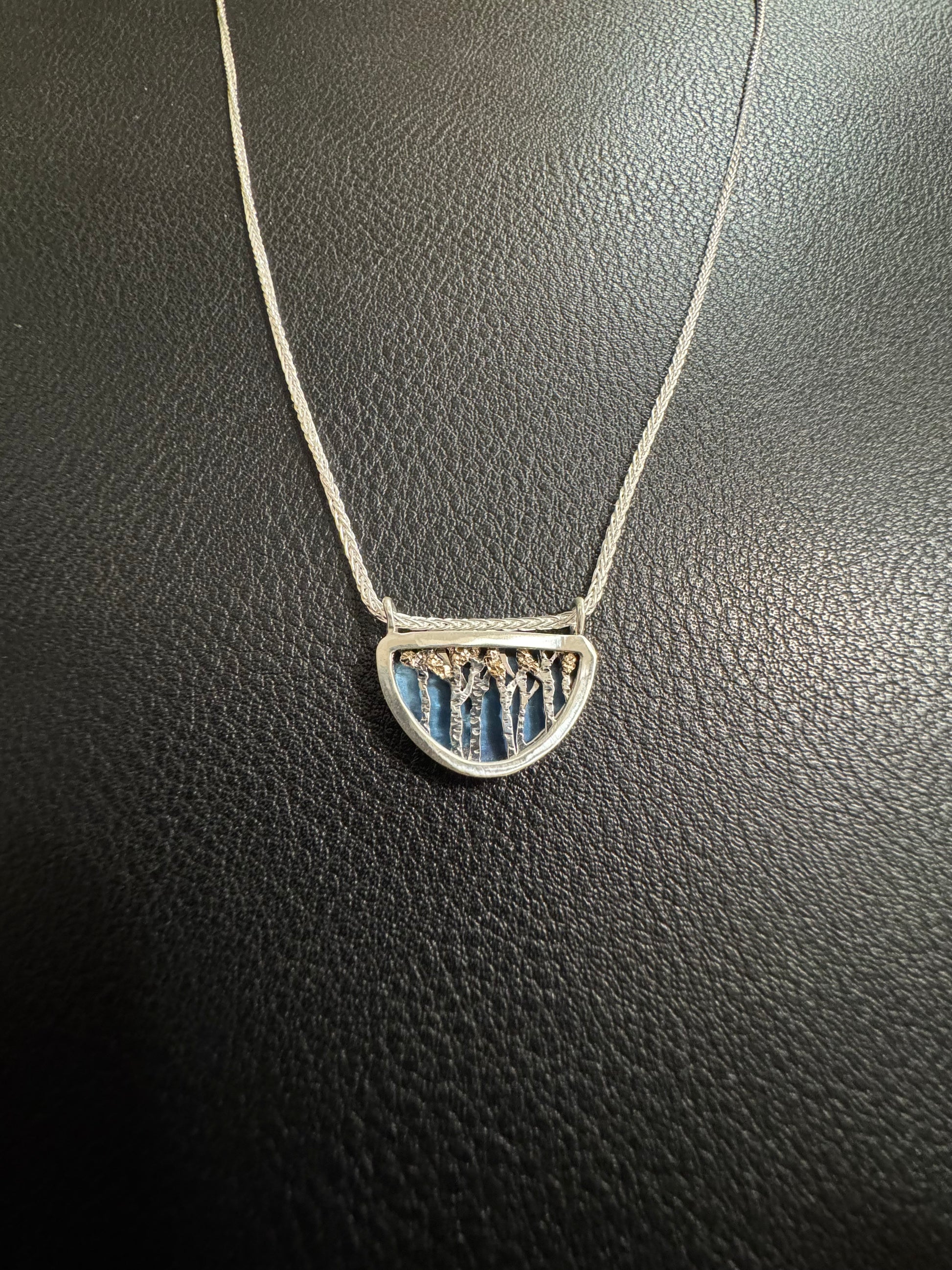 Necklace with a pendant on a dark textured surface