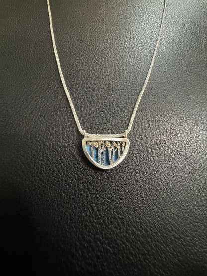 Necklace with a pendant on a dark textured surface