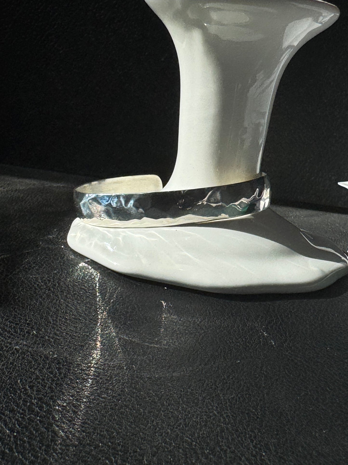 Metallic handle on a black leather surface