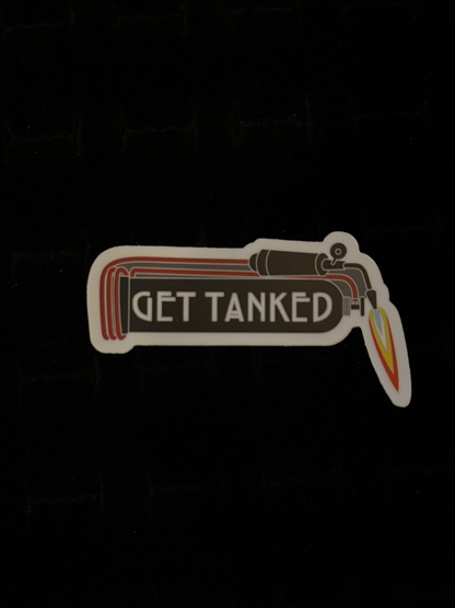 A sticker with a graphic of a gas tank and the phrase 'GET TANKED' written on it, predominantly in red, white, and black colors.