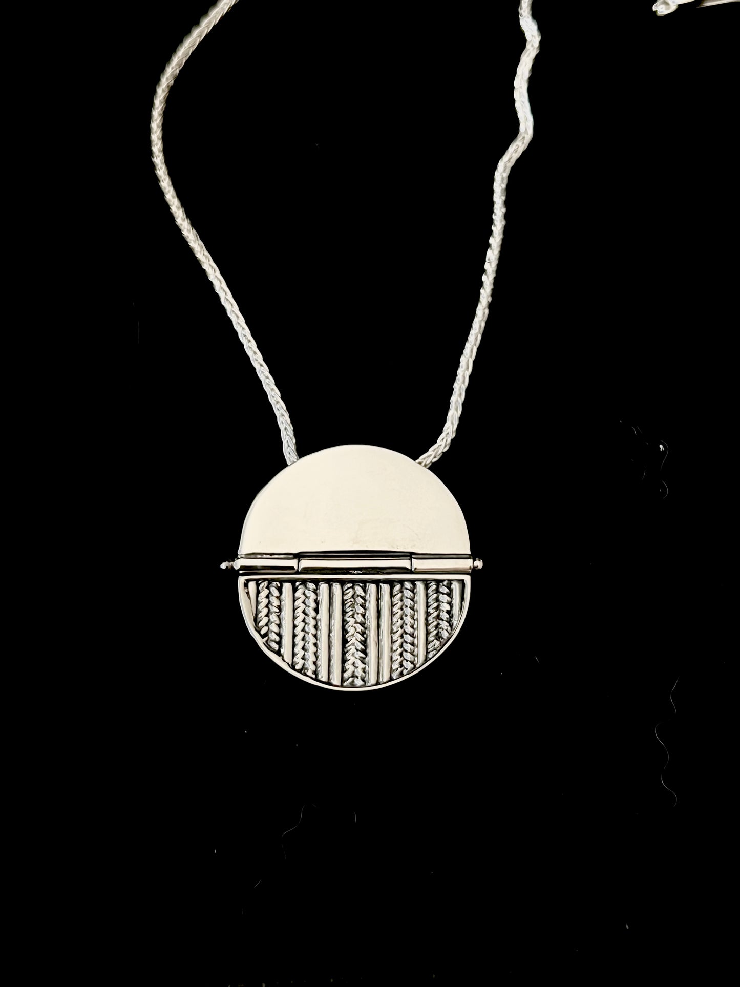 Sterling Silver Hinged Sweater Pendant Necklace – handcrafted sterling silver round disc pendant with knit-texture pattern on hinged bail and box chain, black background