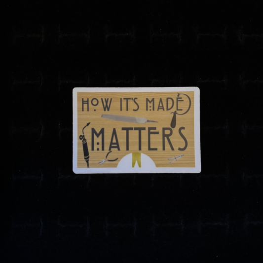 A rectangular sticker with the text 'HOW ITS MADE MATTERS' displayed on it, along with illustrations of crafting tools like a saw, torch, and pliers.