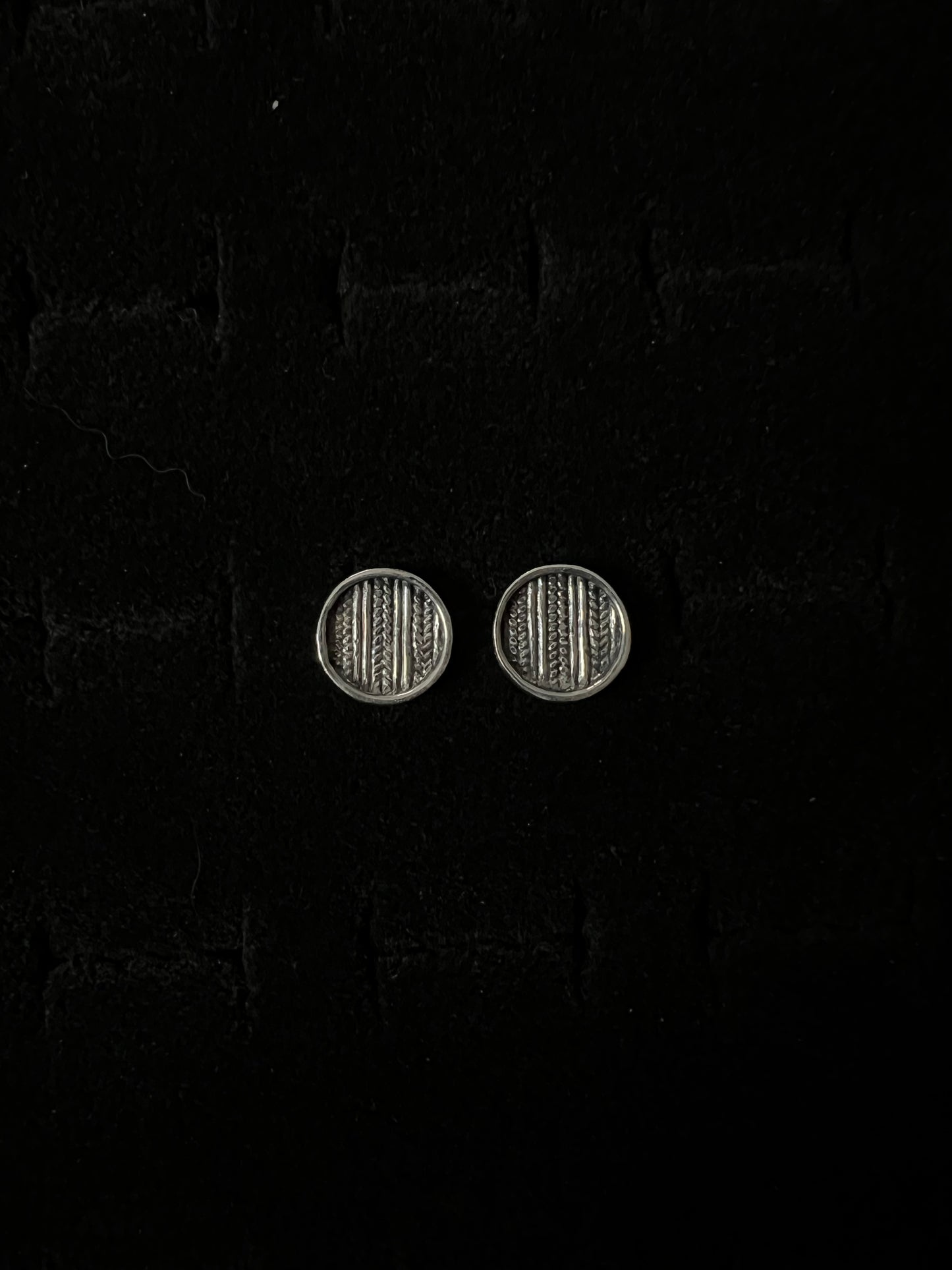 Medium Sweater Post Earrings – pair of handcrafted sterling silver round disc stud earrings with knit-texture pattern, black velvet background