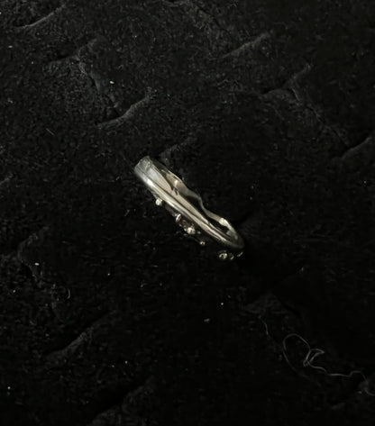 Narrow Feather Ring – front view of handcrafted sterling silver narrow feather band ring, black background