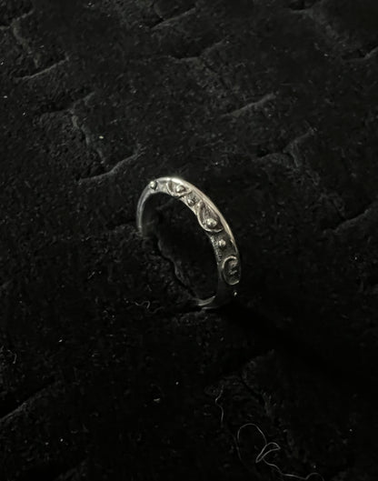 Narrow Feather Ring – side view of sterling silver narrow oxidized feather-texture band ring, black background