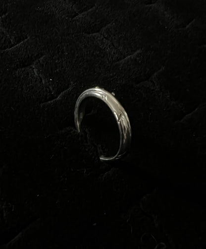 Narrow Feather Ring – overhead view of handcrafted sterling silver narrow feather band ring, black background
