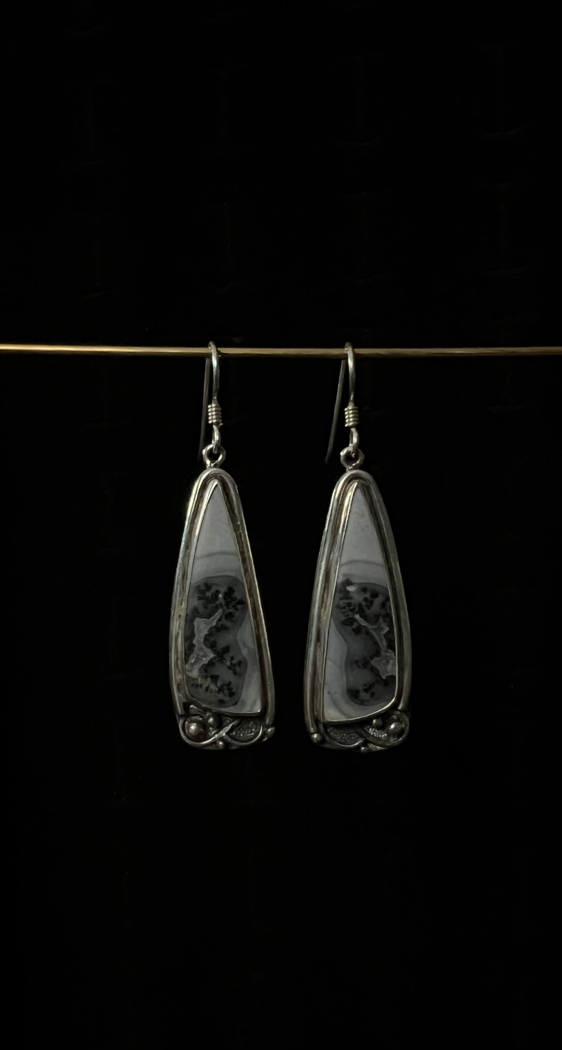 One-Of-A-Kind Artisanal Earrings – unique handcrafted sterling silver mixed-metal drop earrings with oxidized texture and gemstone detail, black background