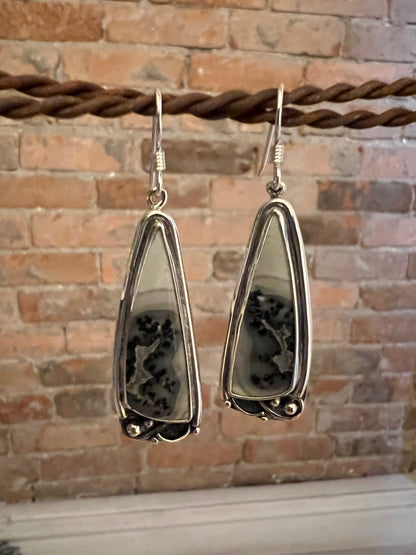One-Of-A-Kind Artisanal Earrings – detail shot of handcrafted sterling silver one-of-a-kind artisanal earrings showing texture and gemstone, black background