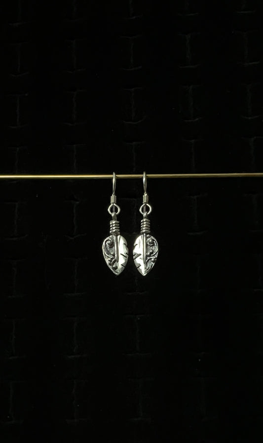 Petite Feather Earrings – pair of handcrafted sterling silver small oxidized feather drop earrings with detailed quill and barb texture on french hooks, black background