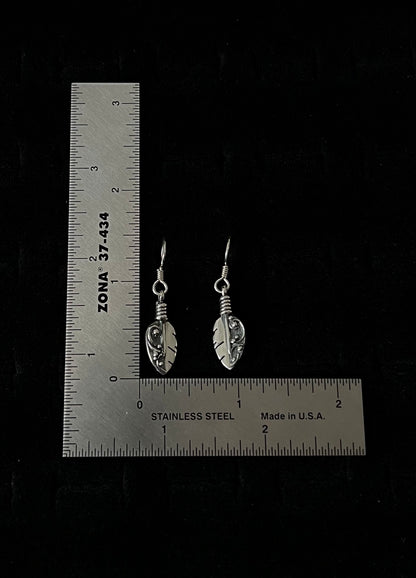Petite Feather Earrings – overhead view of handcrafted sterling silver petite oxidized feather drop earrings, black background