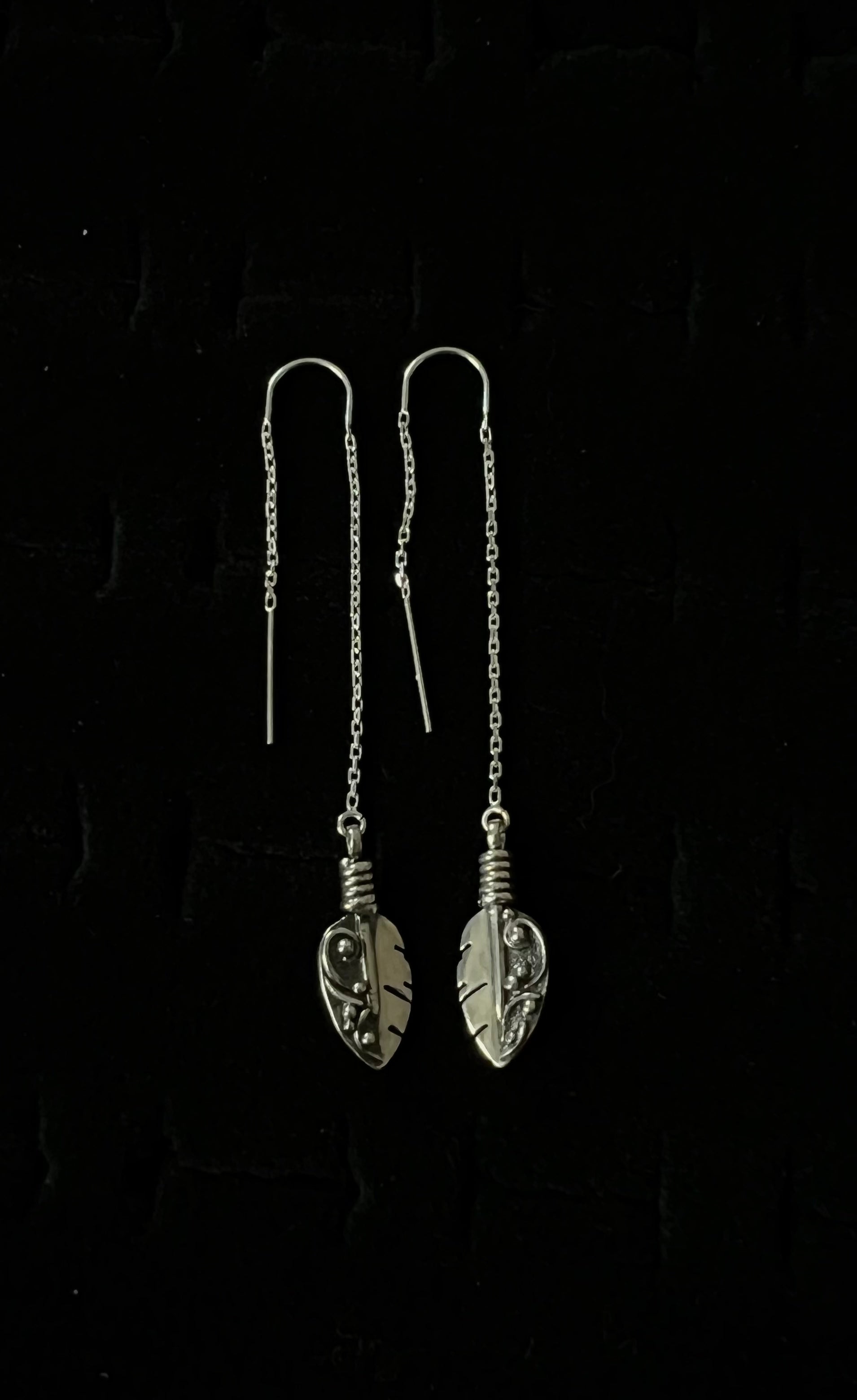 Petite Feather Threaders – front view of handcrafted sterling silver petite feather threader earrings, black background