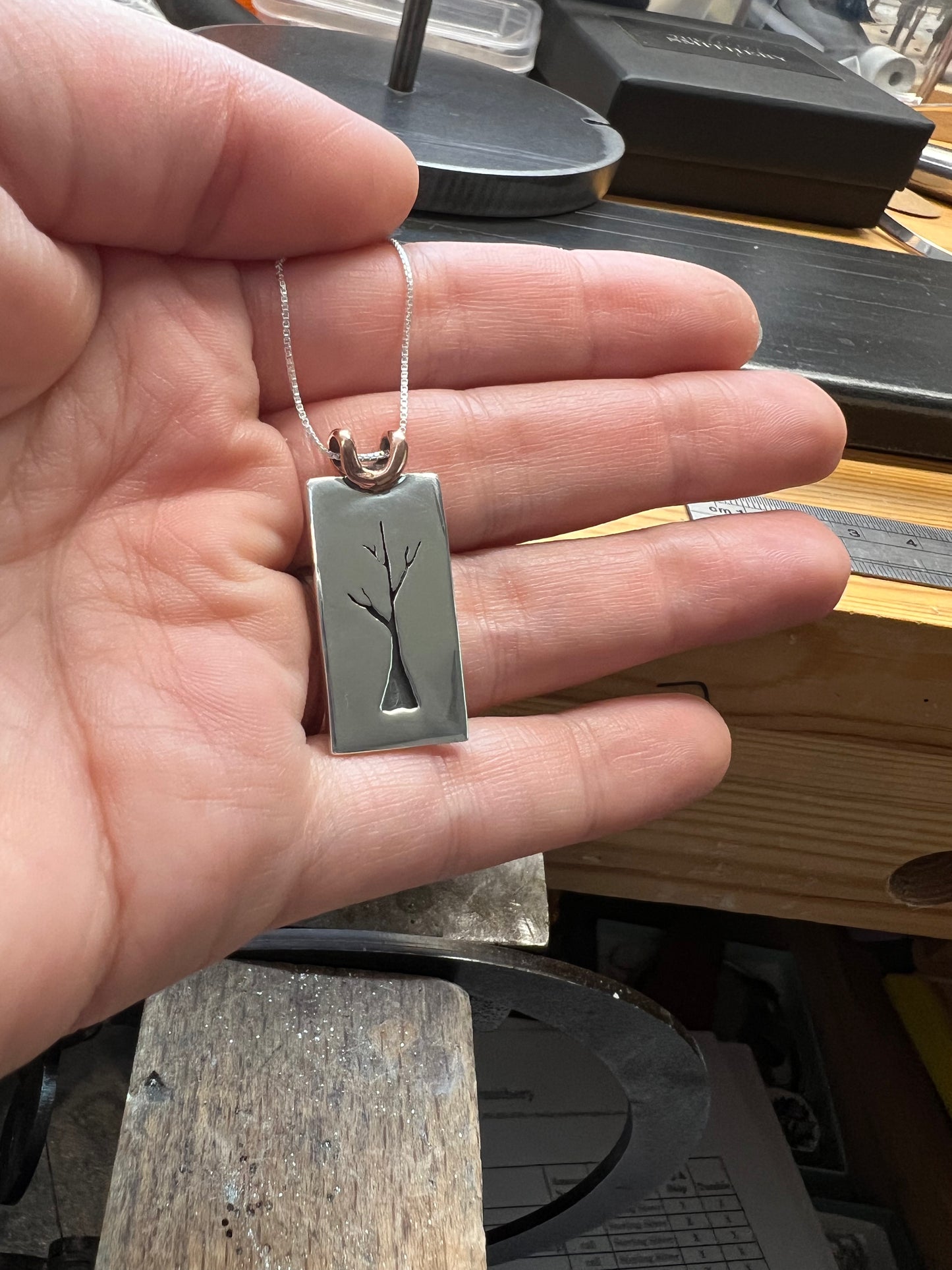 Sapling Tree Pendant one-of-a-kind – close-up of handcrafted sterling silver oxidized sapling tree pendant showing branch and leaf detail, black background