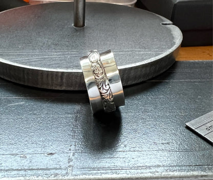 Spinner Ring – close-up of sterling silver spinner ring showing textured rotating outer band detail, black background