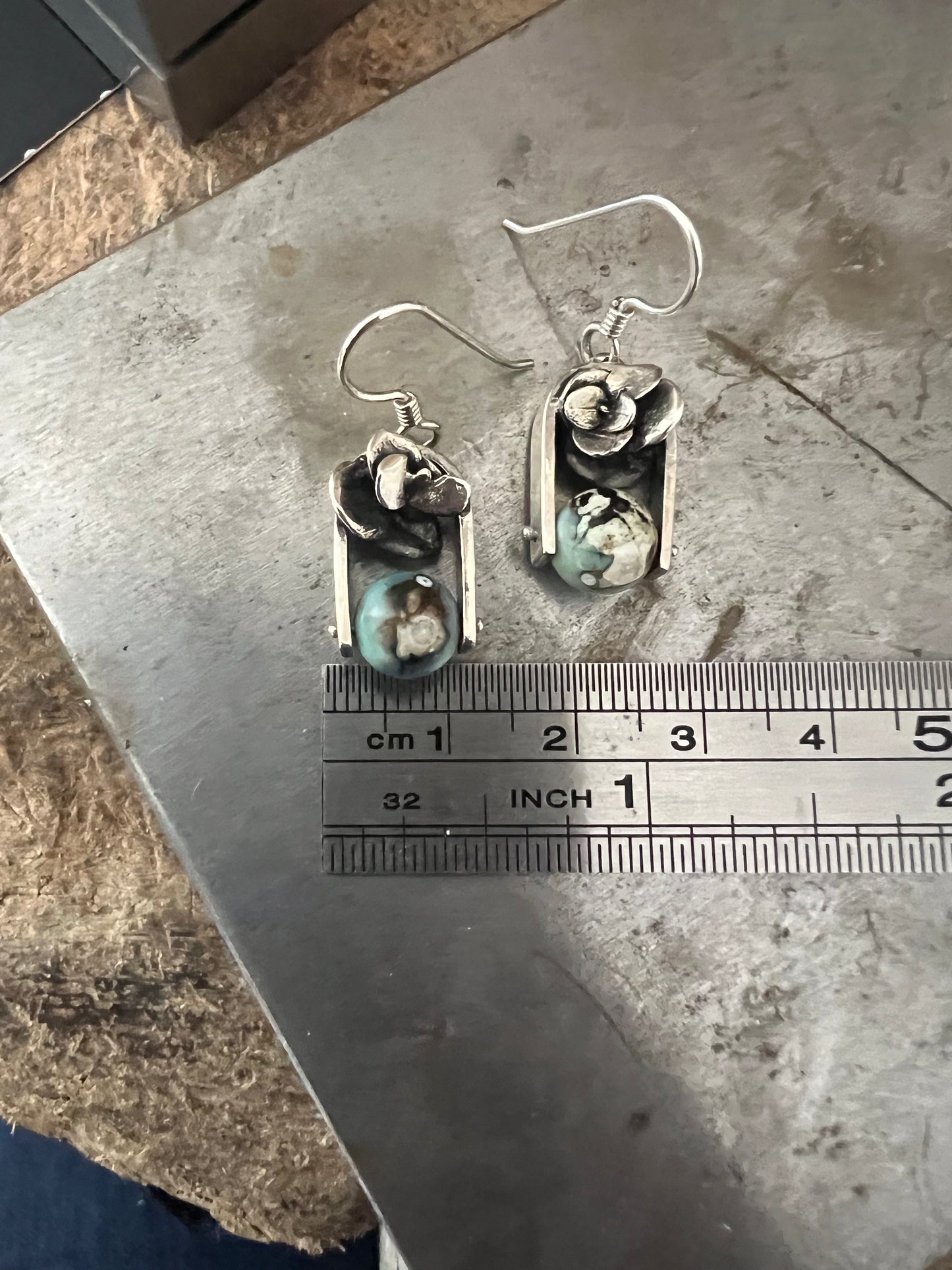 Succulent Earrings one-of-a-kind – size reference showing handcrafted sterling silver succulent drop earrings next to ruler, black background