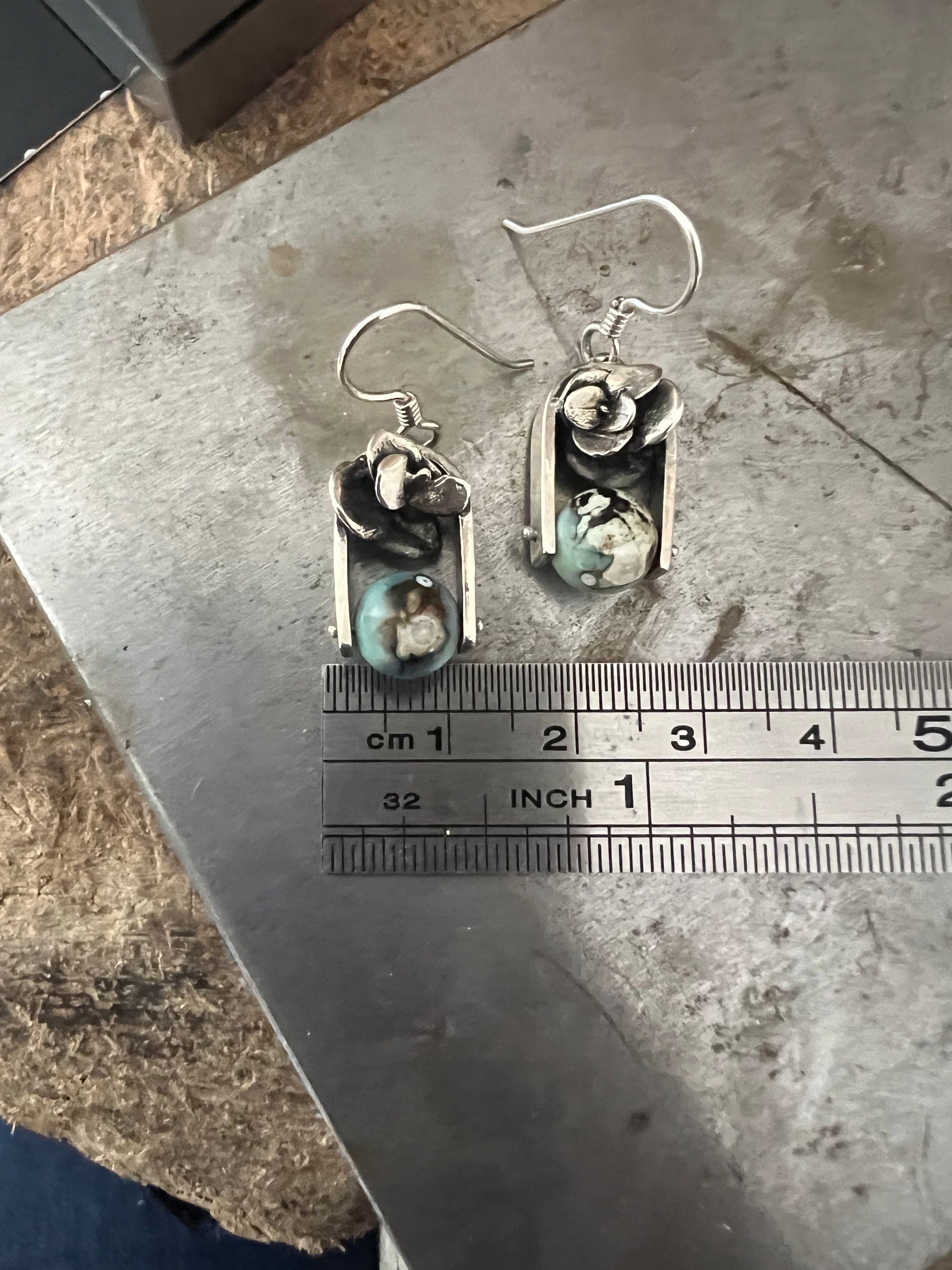 Succulent Earrings one-of-a-kind – size reference showing handcrafted sterling silver succulent drop earrings next to ruler, black background