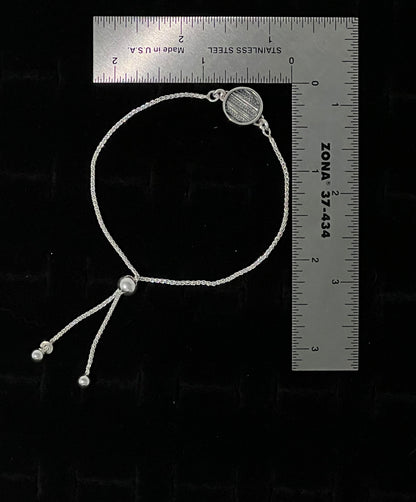Sterling Silver Adjustable Sweater Bracelet – size reference showing sterling silver knit-texture disc bracelet approximately 7 inches long next to ruler, black background