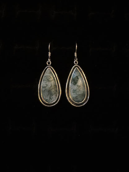 A pair of Teal Moss Agate earrings with a teardrop shape, mounted on Sterling Silver hooks.