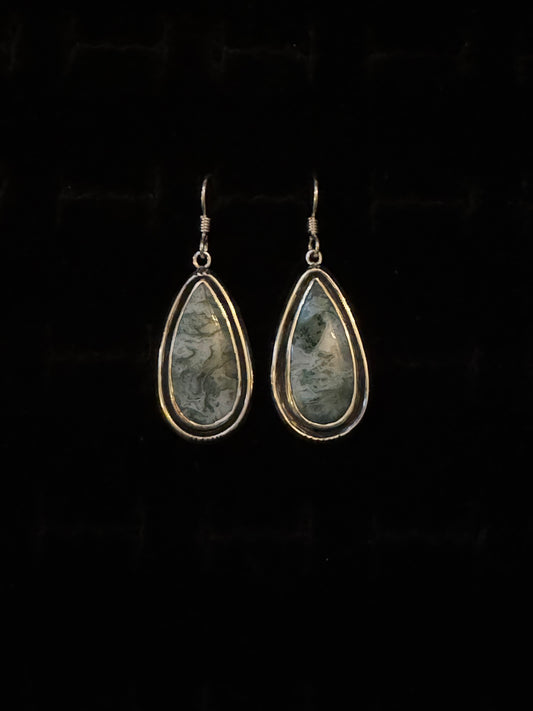 A pair of Teal Moss Agate earrings with a teardrop shape, mounted on Sterling Silver hooks.