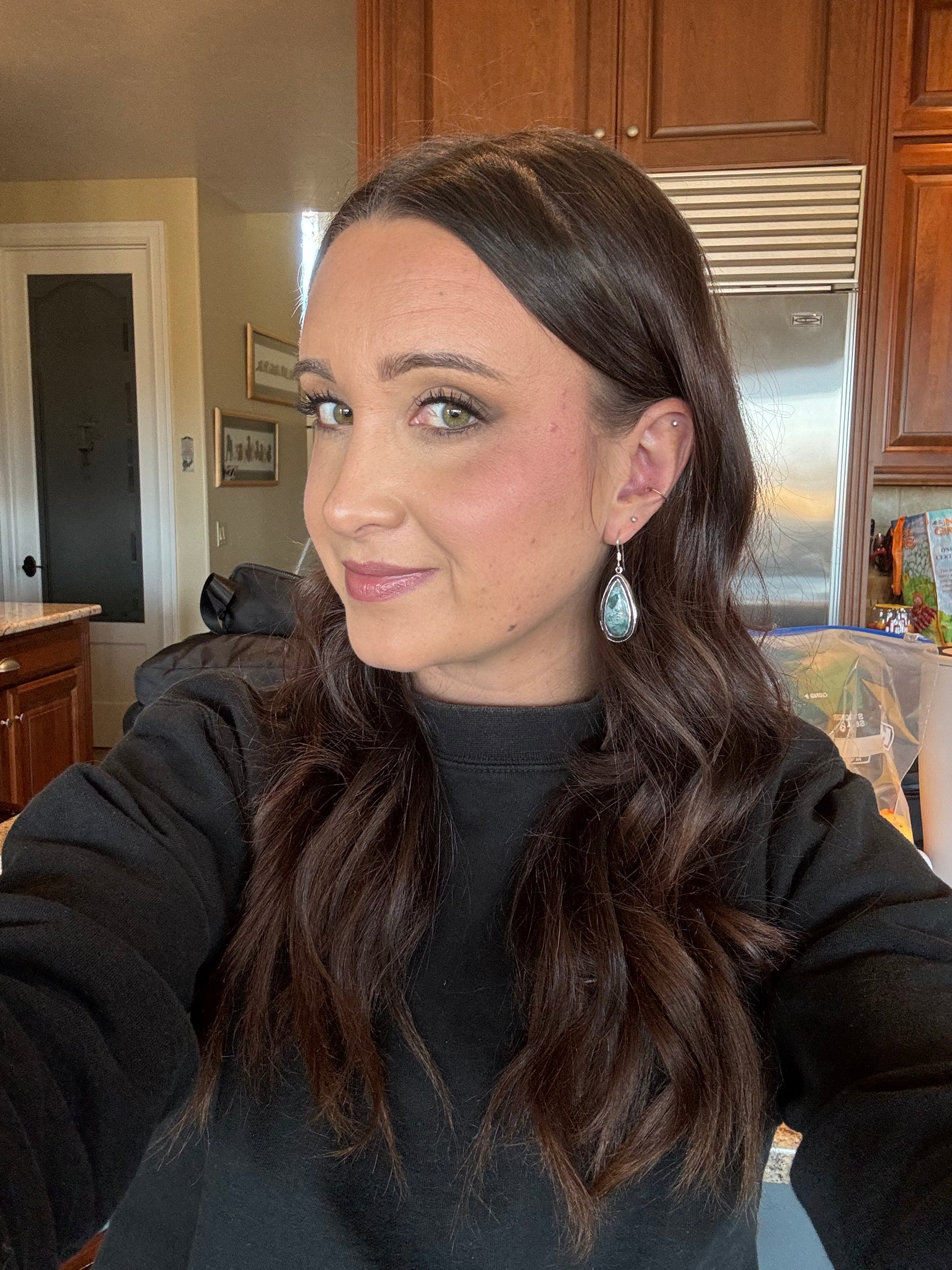 Teal Moss Agate Earrings – lifestyle shot of model wearing handcrafted sterling silver teal moss agate teardrop earrings with black turtleneck