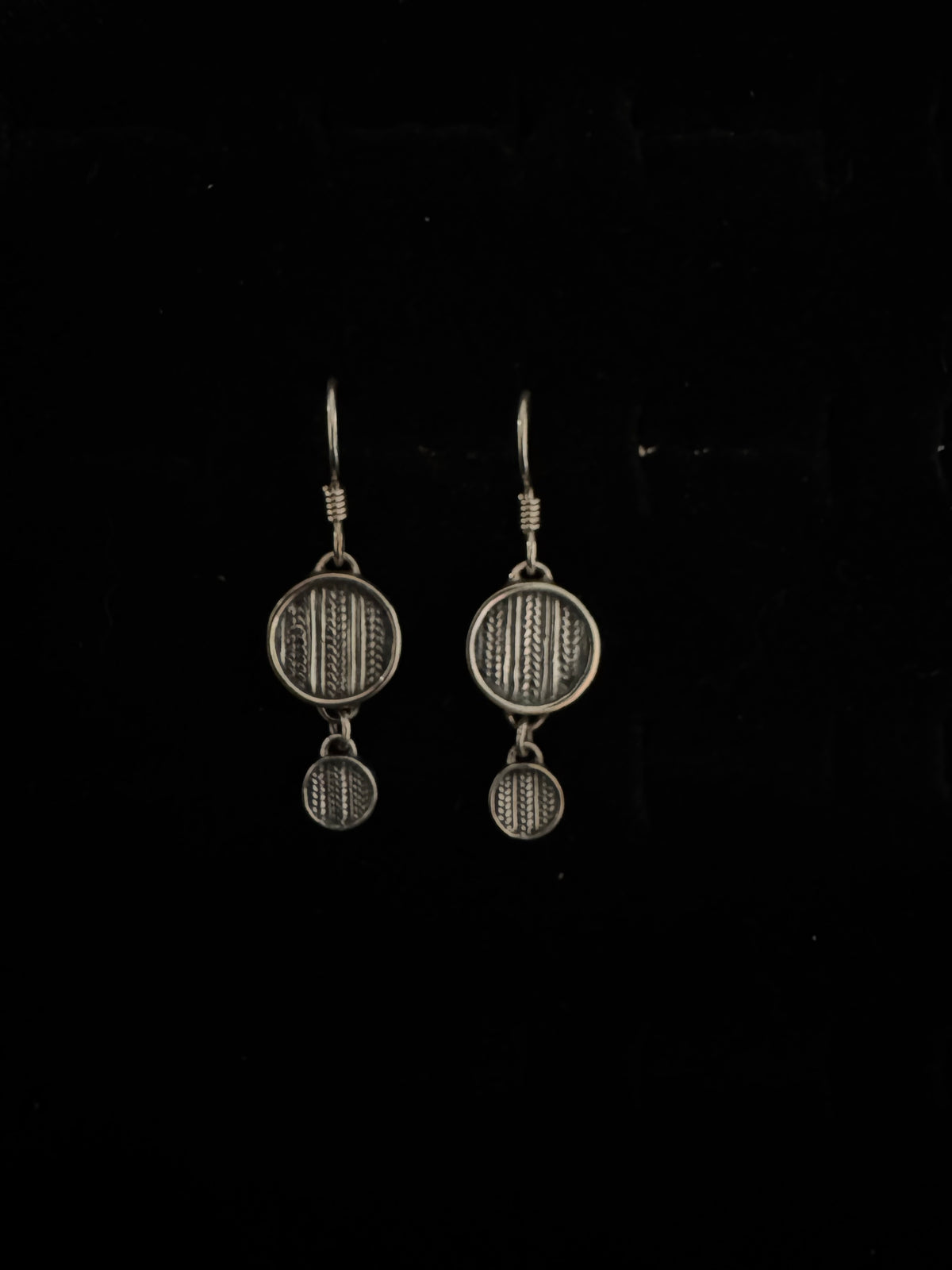 Two metallic objects on a black background