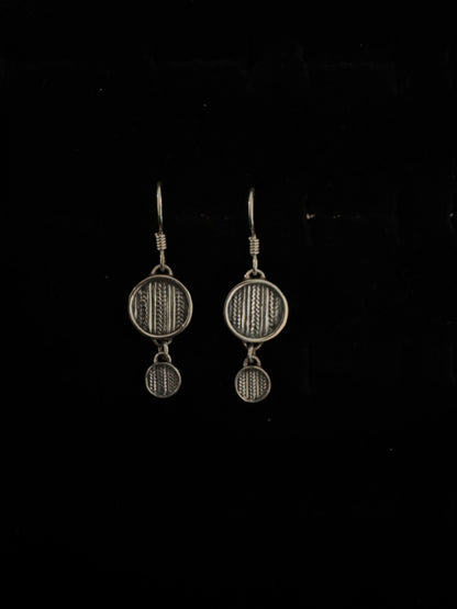 Two metallic objects on a black background