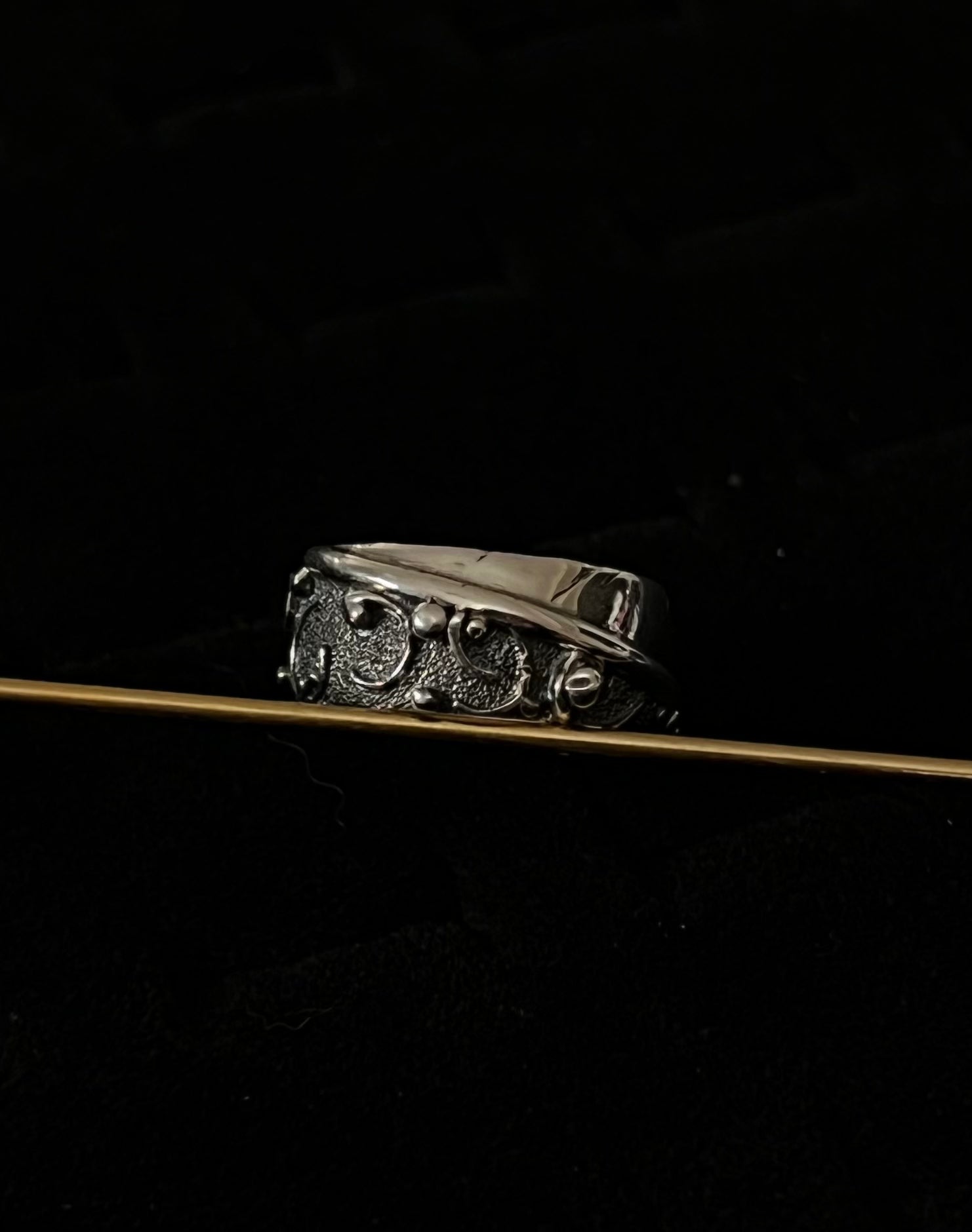 Wide Feather Ring – handcrafted sterling silver wide band ring with oxidized feather texture pattern, black background