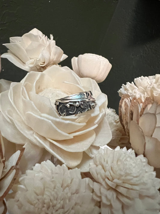 Wide Feather Ring – close-up of sterling silver wide feather-texture band ring showing oxidized detail, black background