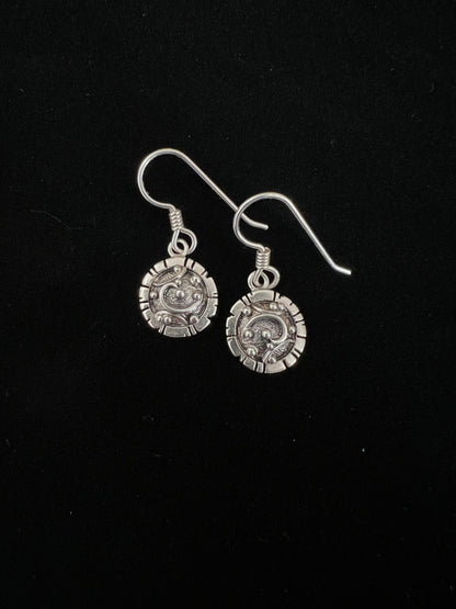 Artisanal Elements Earrings – overhead view of sterling silver artisanal elements drop earrings showing mixed-metal texture detail, black background