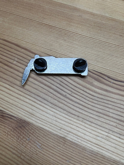 "Get Tanked" enamel pin – back view showing two butterfly clasps hardware on wooden surface