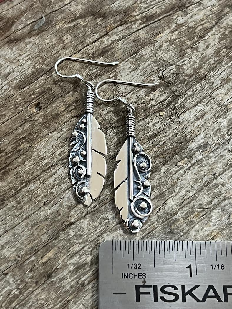 Long Feather Earrings – size reference showing sterling silver long feather drop earrings approximately 2.5 inches long next to ruler, black background
