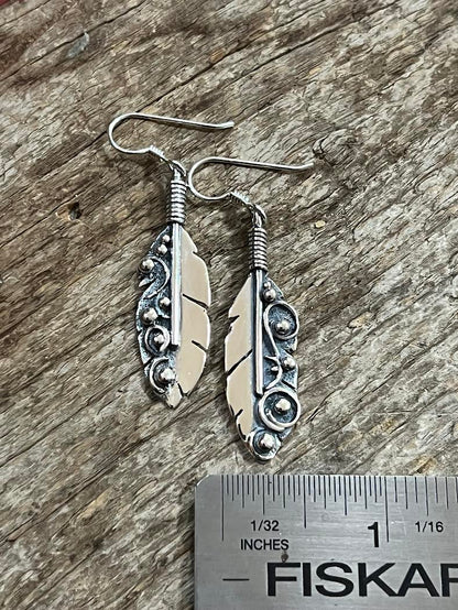 Long Feather Earrings – size reference showing sterling silver long feather drop earrings approximately 2.5 inches long next to ruler, black background