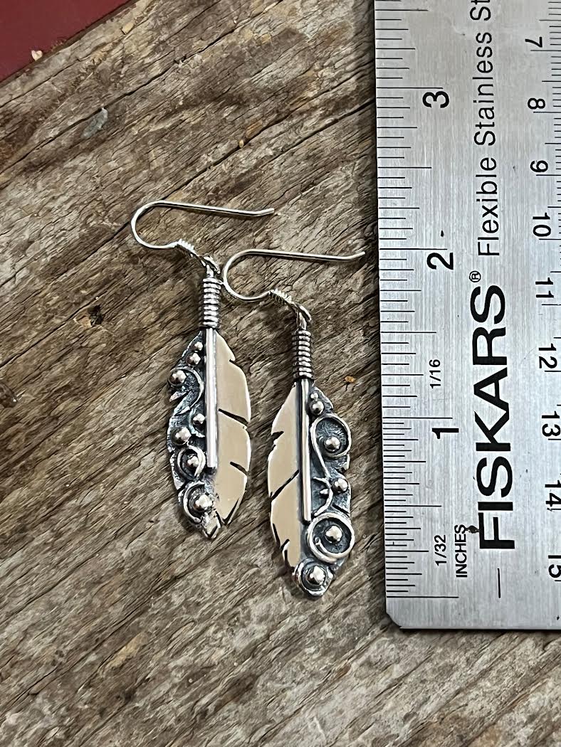Long Feather Earrings – side view of sterling silver long oxidized feather drop earrings showing quill depth detail, black background