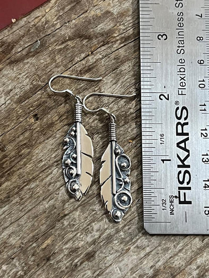 Long Feather Earrings – side view of sterling silver long oxidized feather drop earrings showing quill depth detail, black background